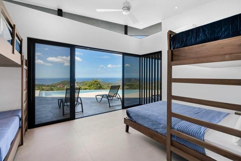 Luxurious Ultramodern Property with Private Suites, Infinity Pool, and Sweeping Ocean and Mountain Views