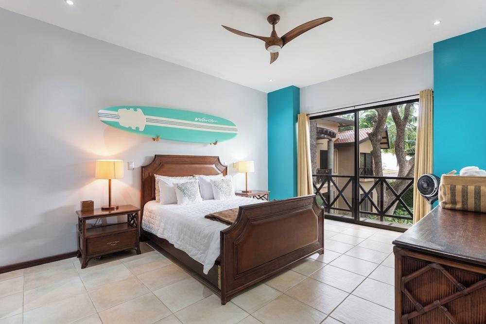 Modern Island-Themed Condo with Floor-to-Ceiling Windows & Garden and Pool Views Within Walking Distance of the Beach